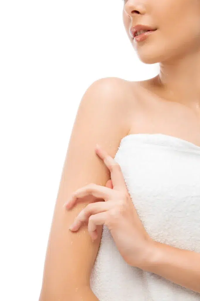 a woman in a towel touching her arm
